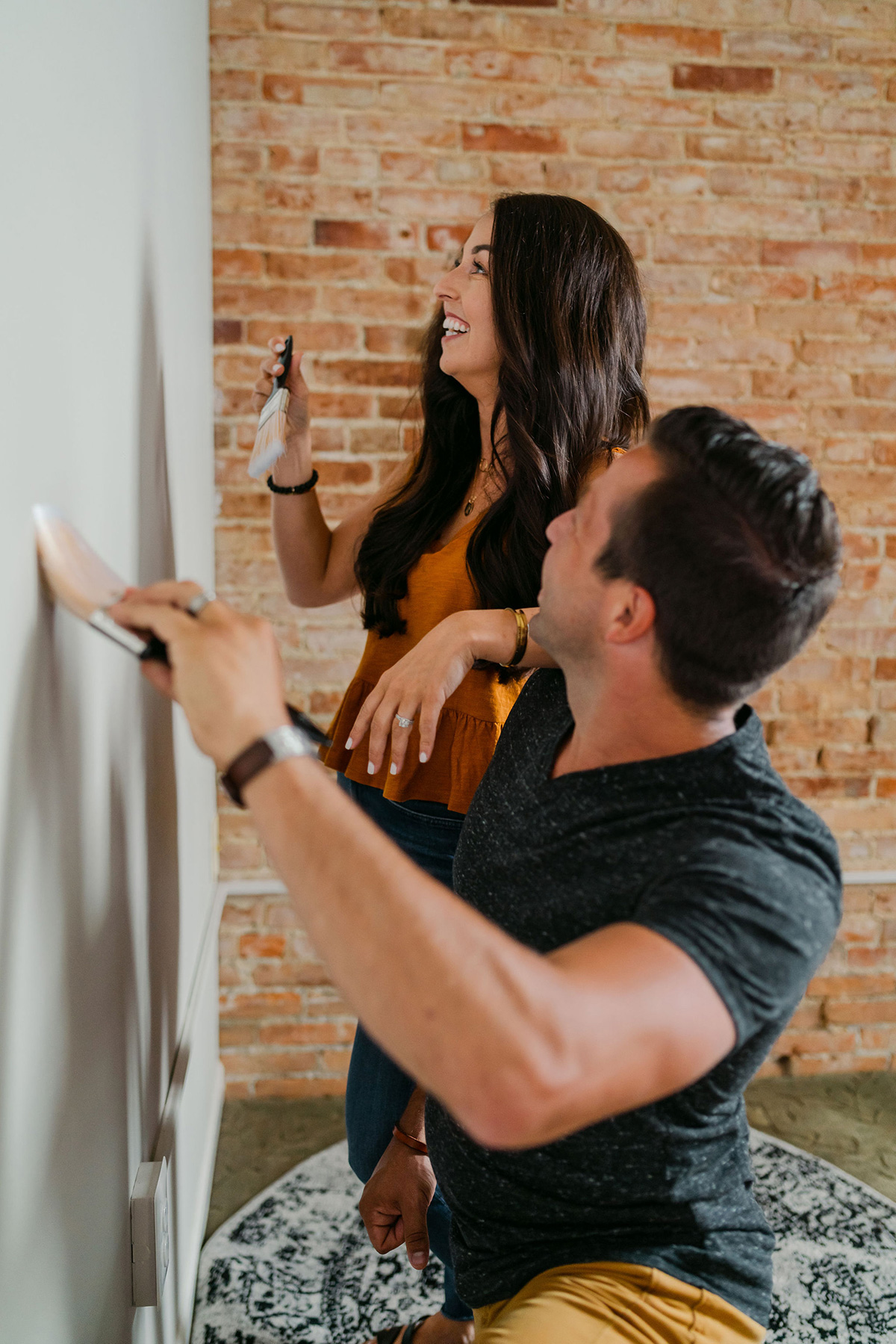 Young couple painting the walls to refresh their home